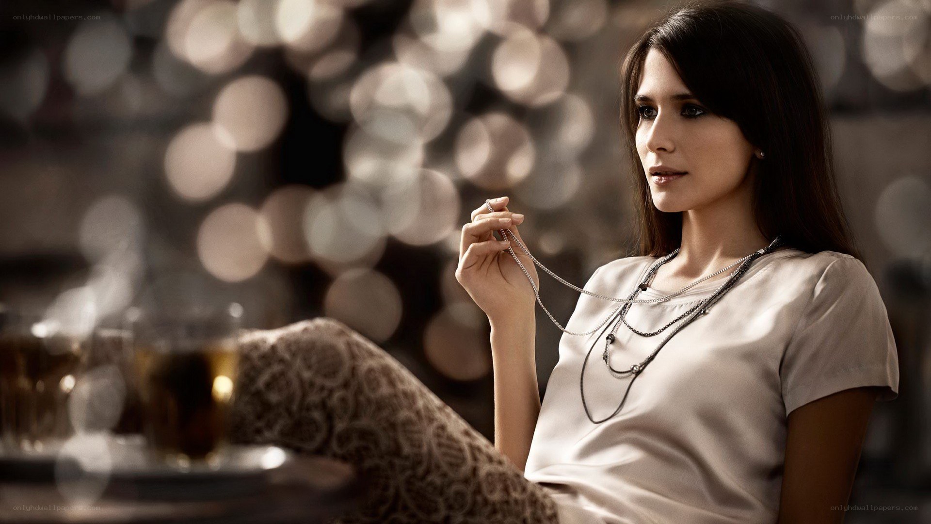 woman holding necklace