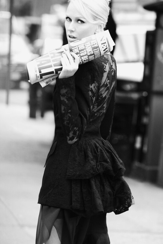 woman holding newspaper on street