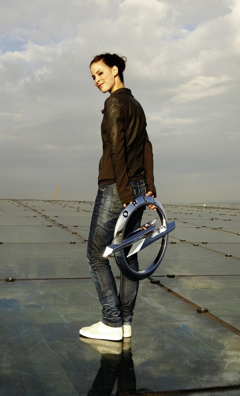 Woman holding Opel logo on rooftop