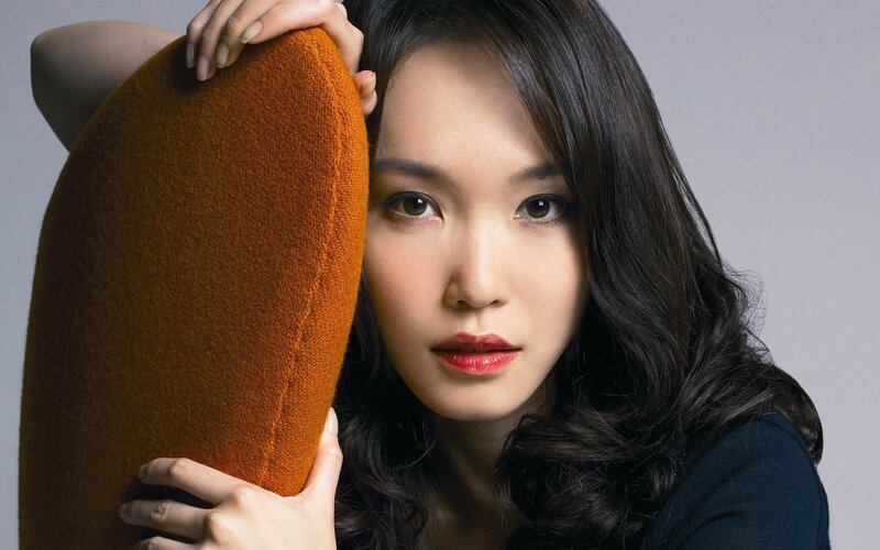 woman holding orange cushion