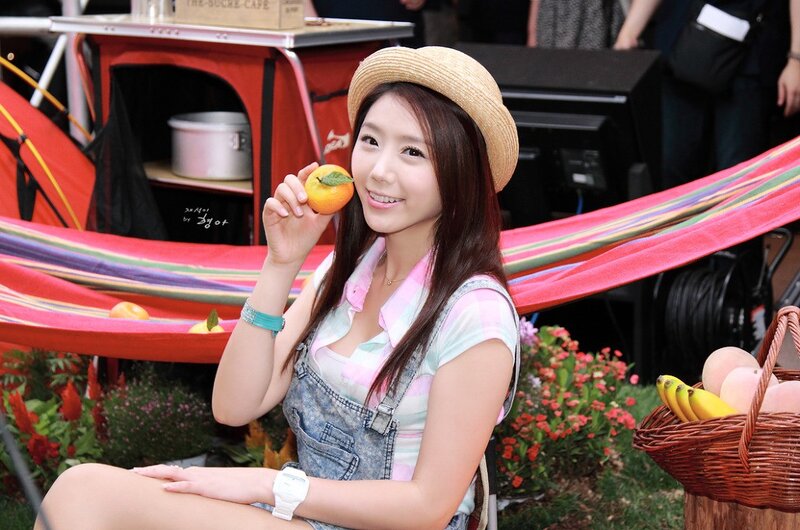 woman holding orange in garden