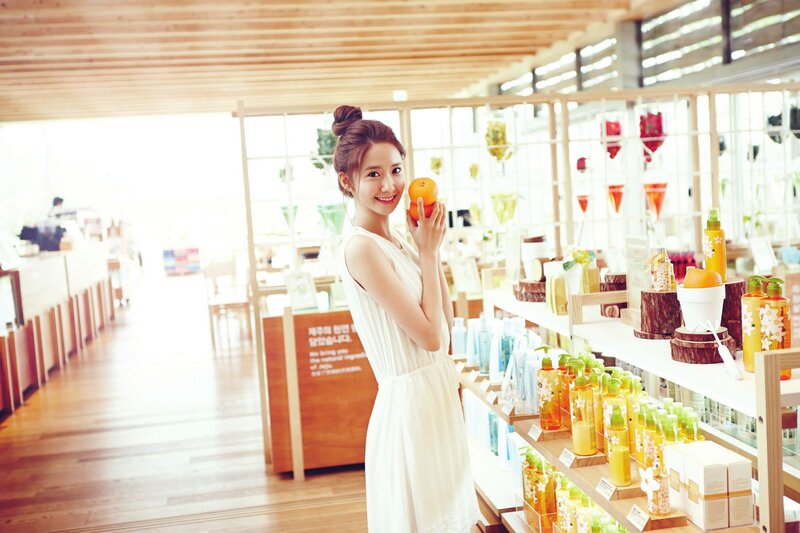 woman holding orange in store