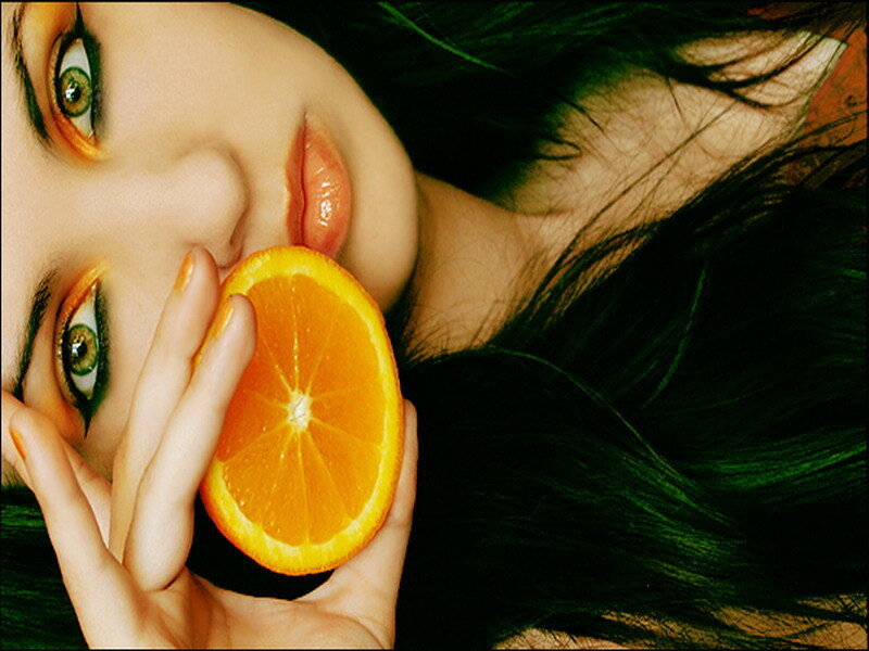 woman holding orange slice