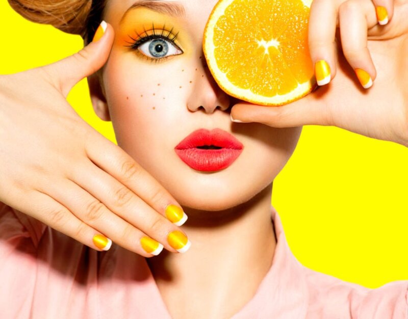 Woman Holding Orange Slice — Yellow