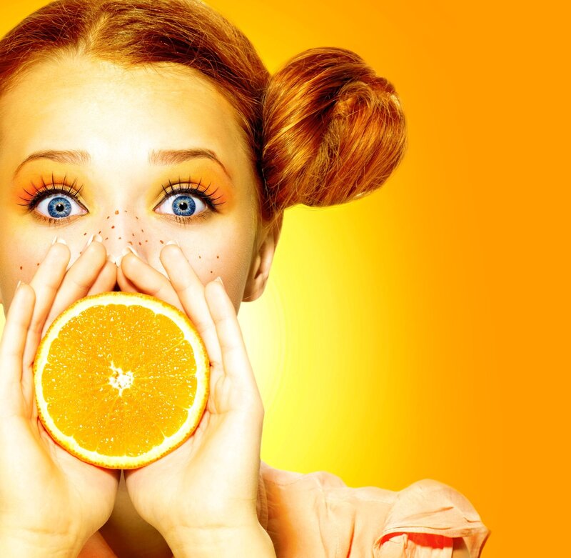 Woman Holding Orange Slice — Yellow, Vibrant