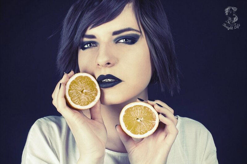 woman holding orange slices
