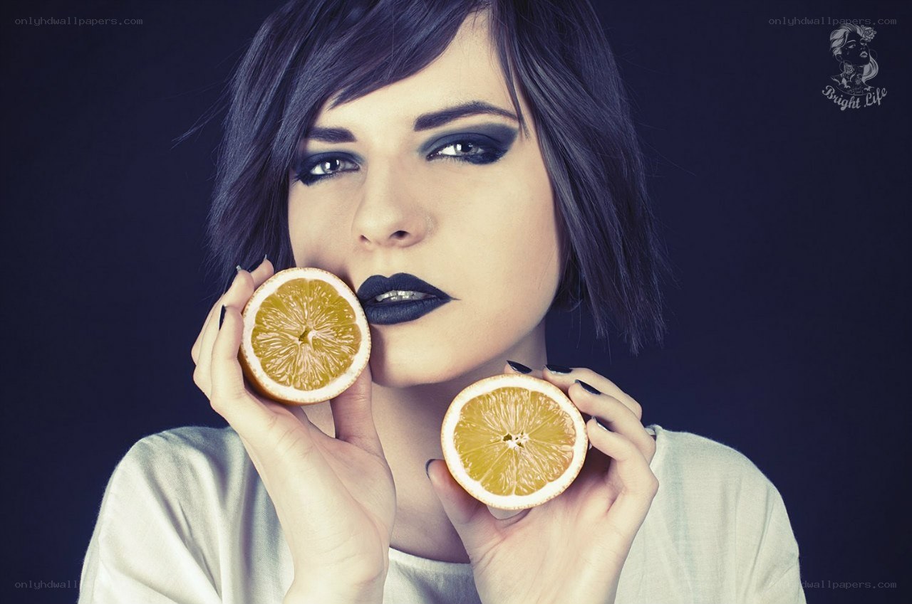 woman holding orange slices