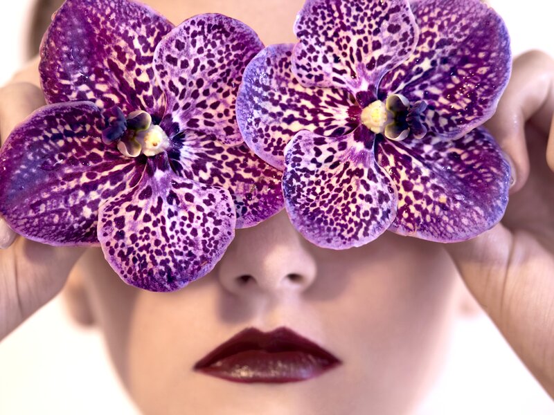 Woman Holding Orchids