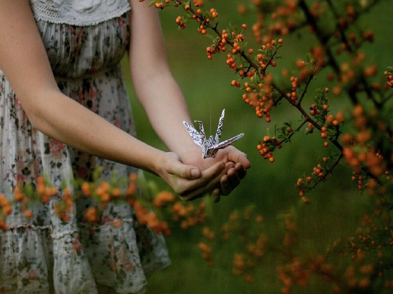 Woman Holding Origami Bird