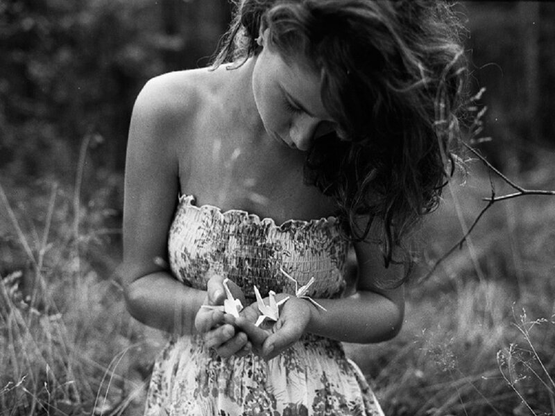 Woman Holding Origami Cranes — Black