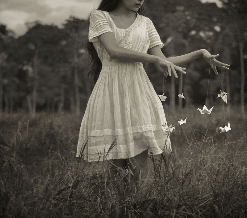 Woman Holding Origami Cranes