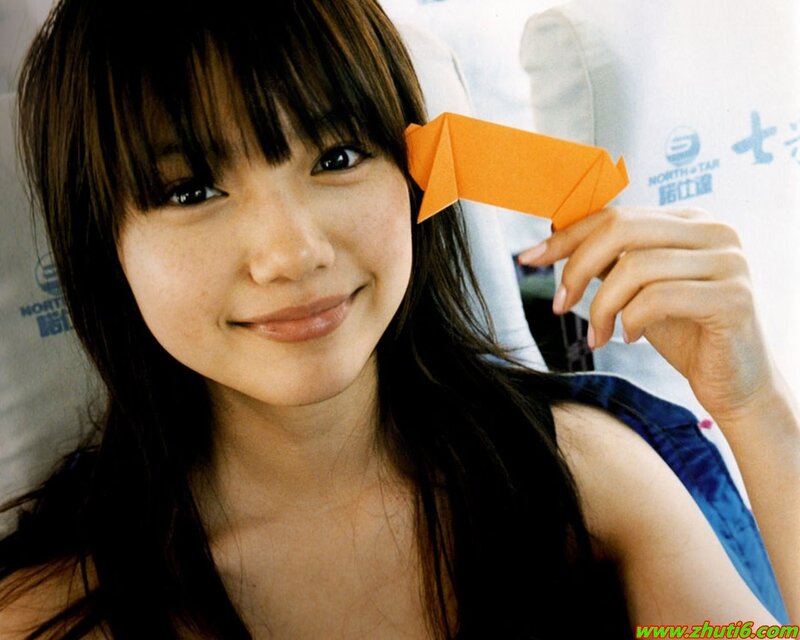 woman holding origami paper