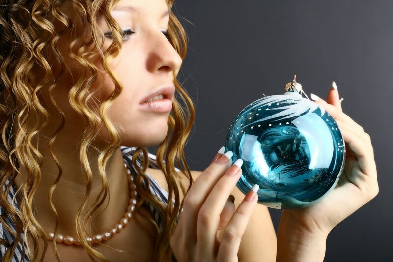 Woman Holding Ornament — Blue