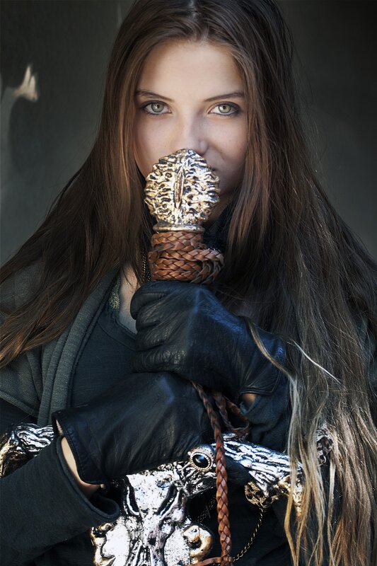 woman holding ornate sword