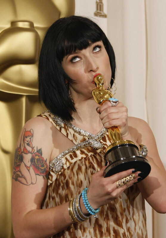 Woman holding Oscar statuette