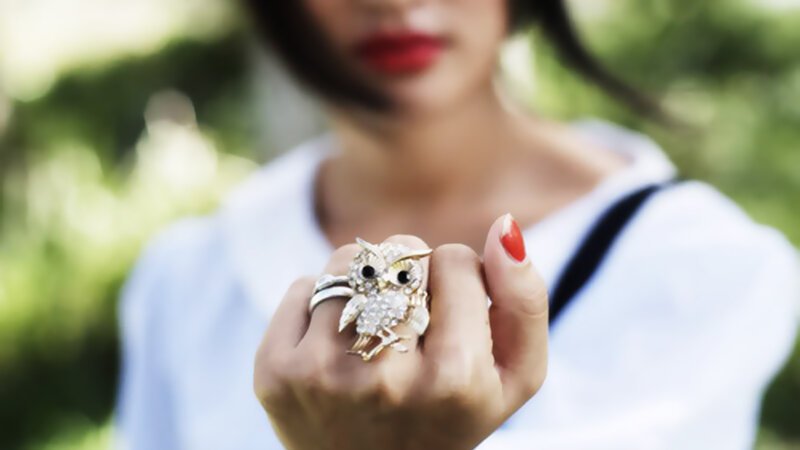Woman Holding Owl Ring