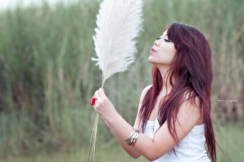 woman holding pampas grass