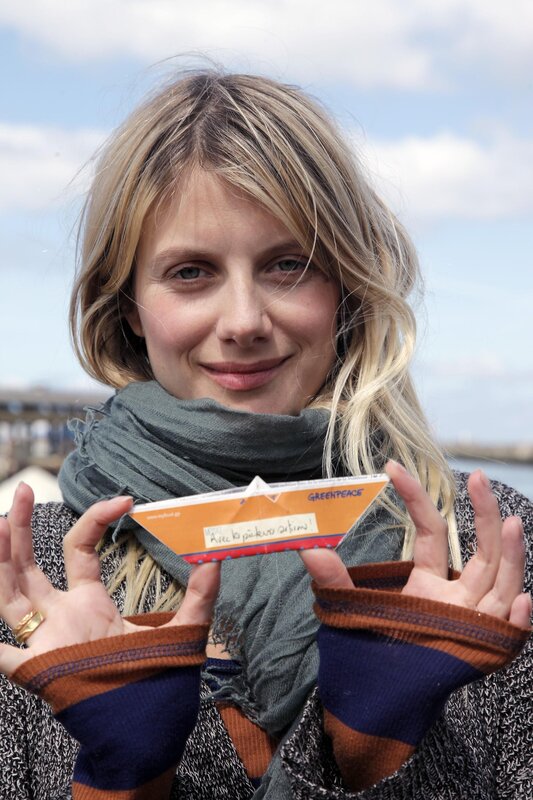 Woman holding paper boat