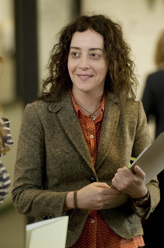 woman holding papers in office