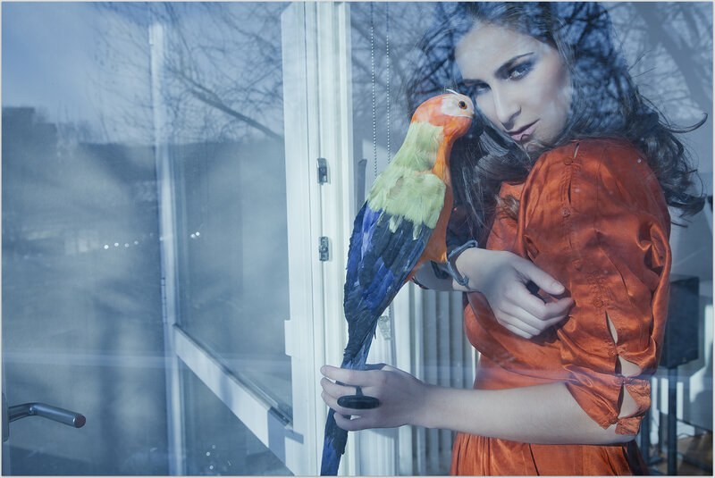 Woman Holding Parrot — Orange
