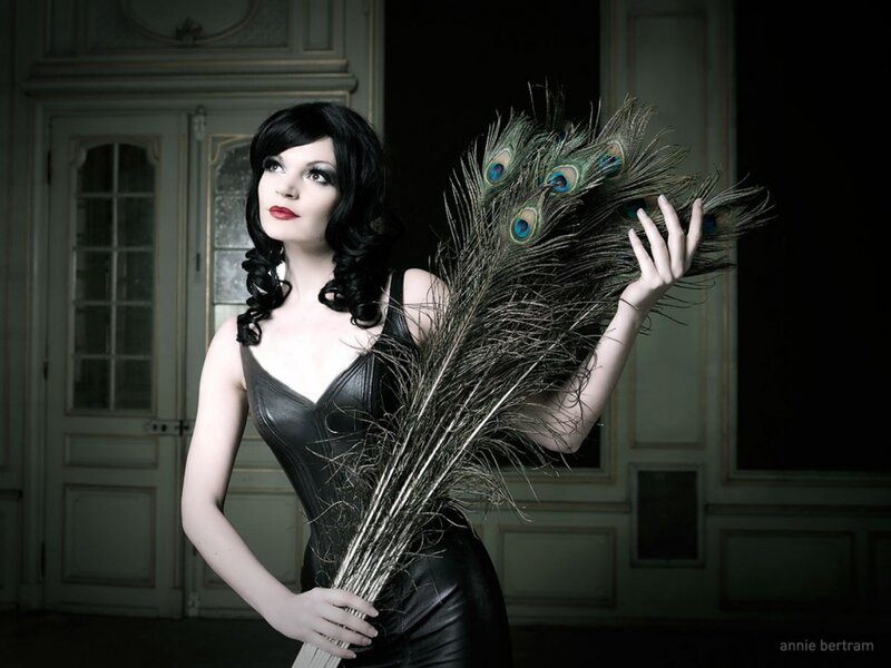 Woman Holding Peacock Feathers — Black
