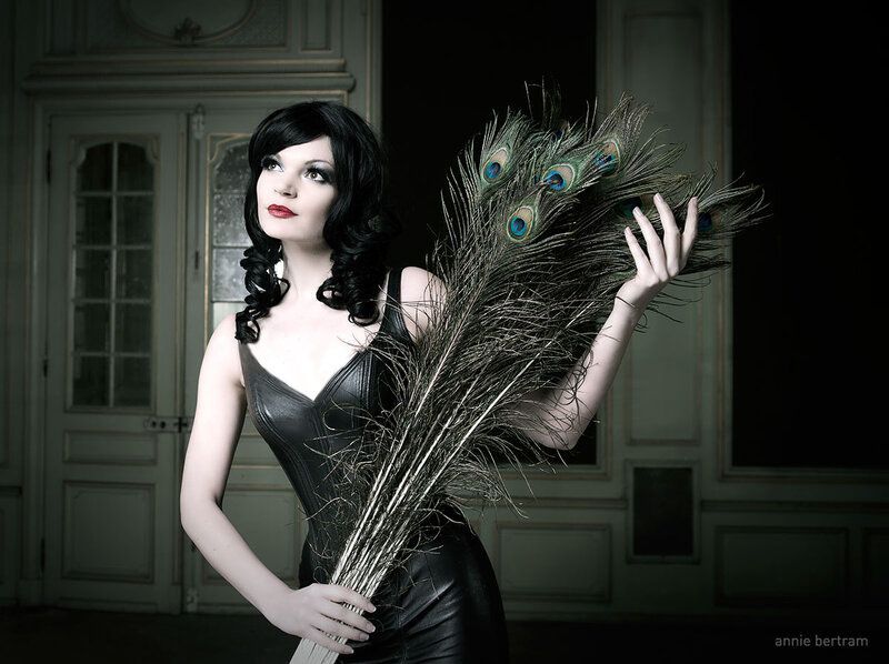 Woman Holding Peacock Feathers