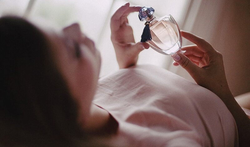 woman holding perfume bottle