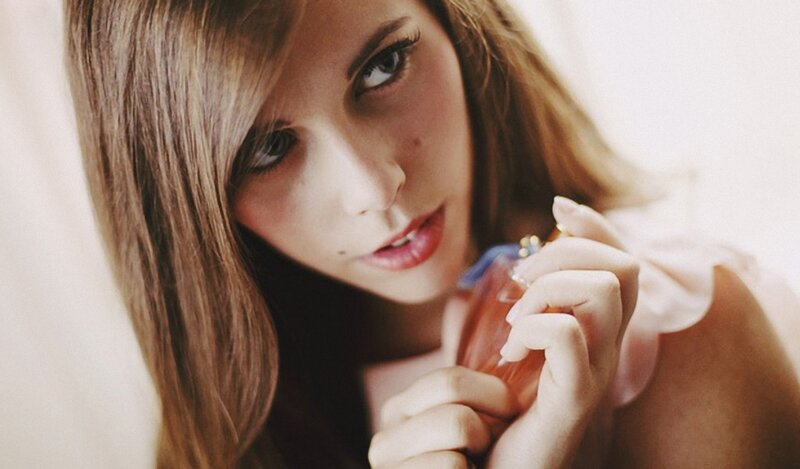 woman holding perfume bottle