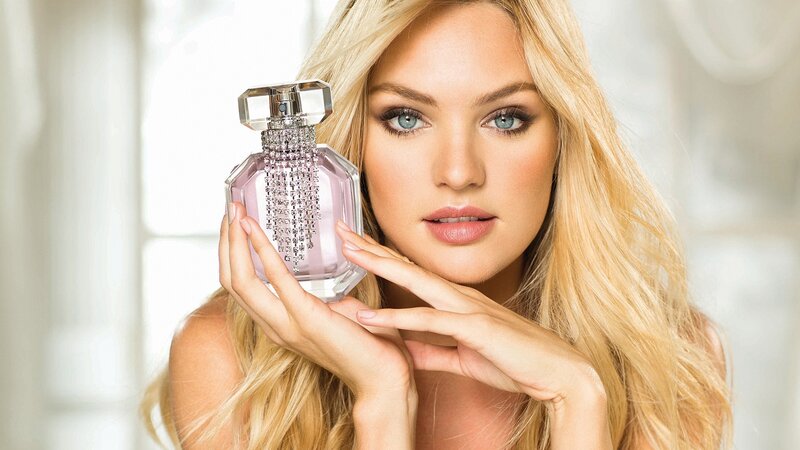 woman holding perfume bottle