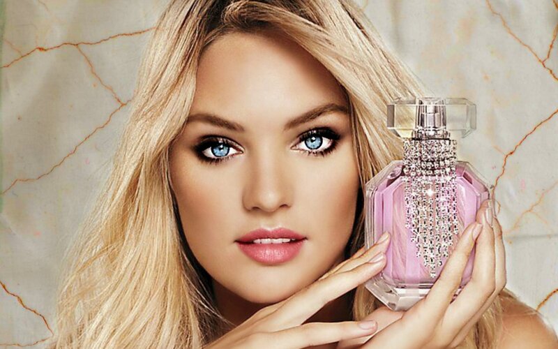 woman holding perfume bottle