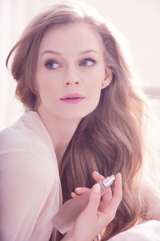 woman holding perfume bottle