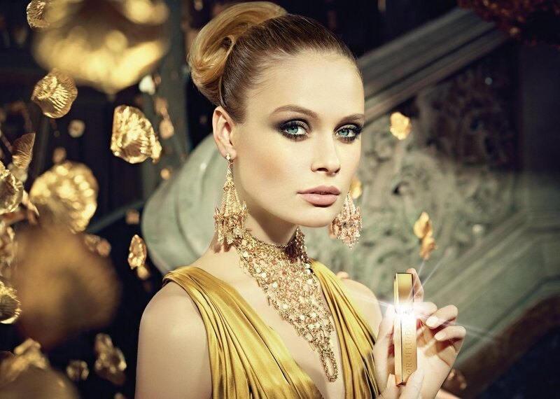 Woman Holding Perfume Bottle — Gold, Dramatic