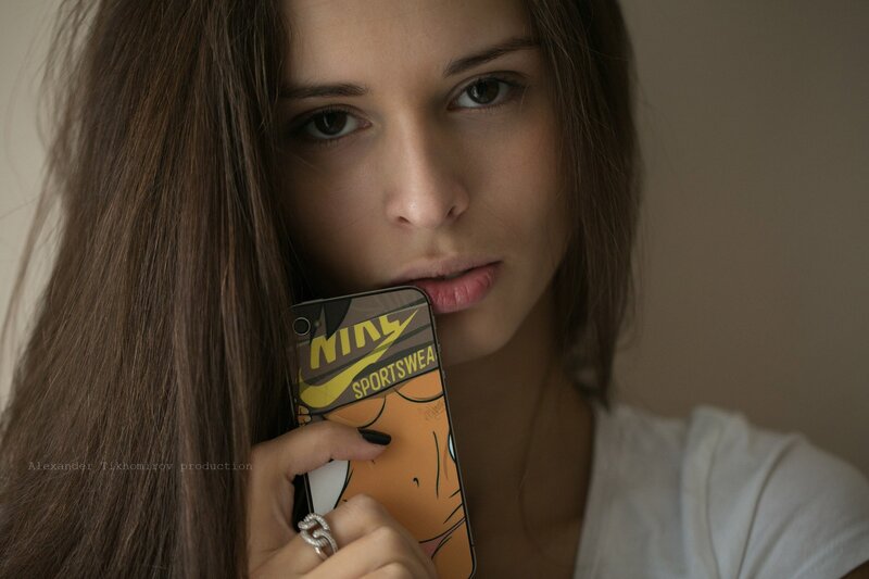 woman holding phone with nike case