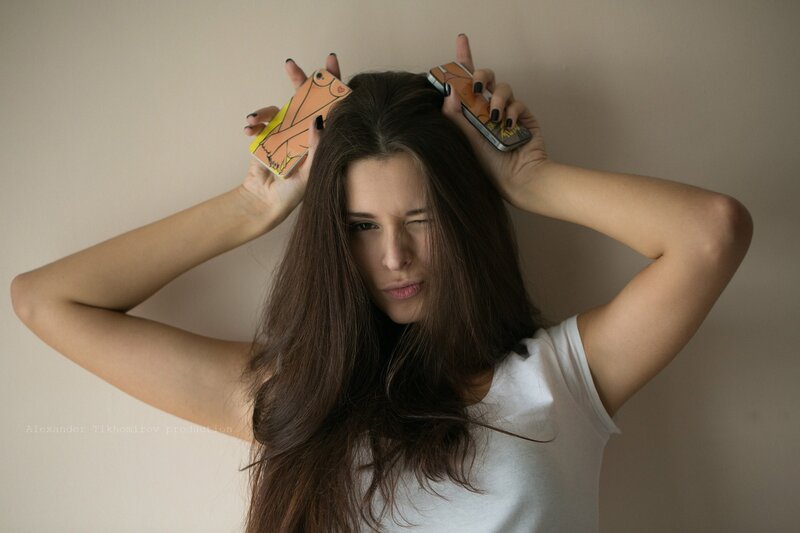 woman holding phones above head