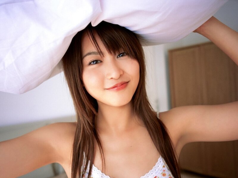 woman holding pillow over head