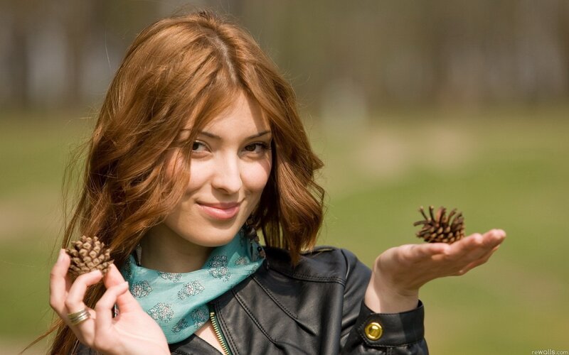 Woman holding pinecones outdoors