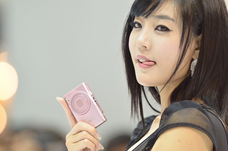 woman holding pink camera