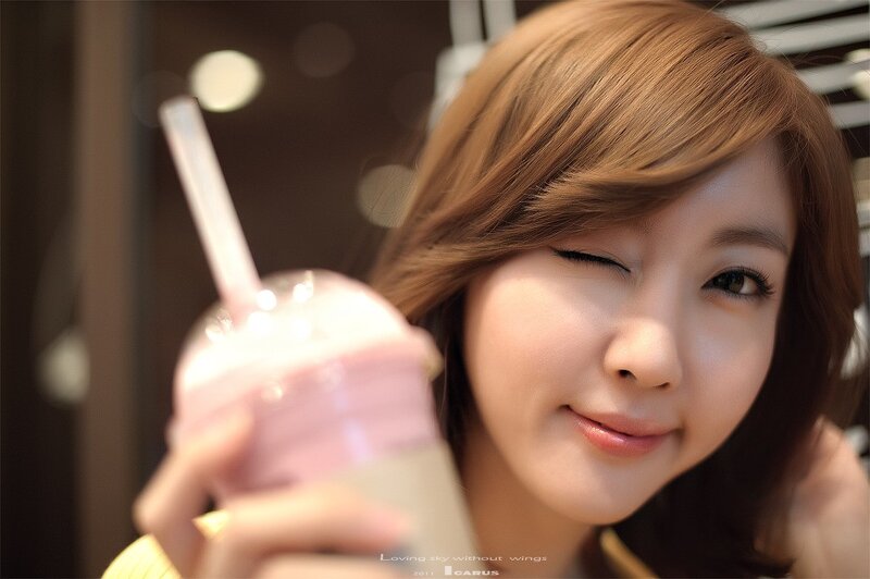 woman holding pink drink