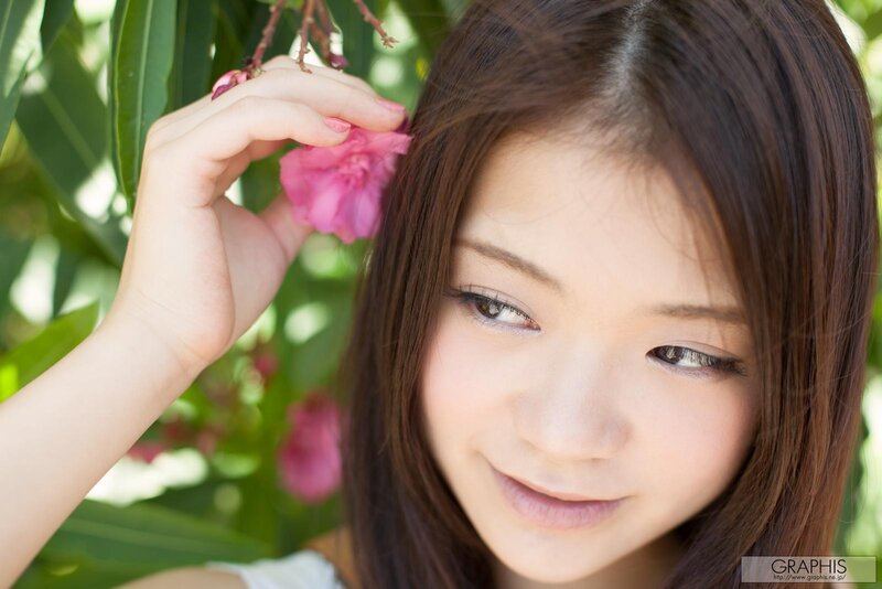 woman holding pink flower