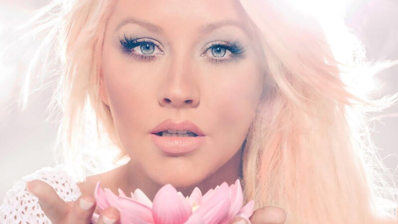 woman holding pink flower