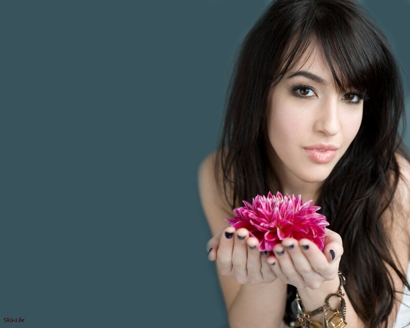 woman holding pink flower