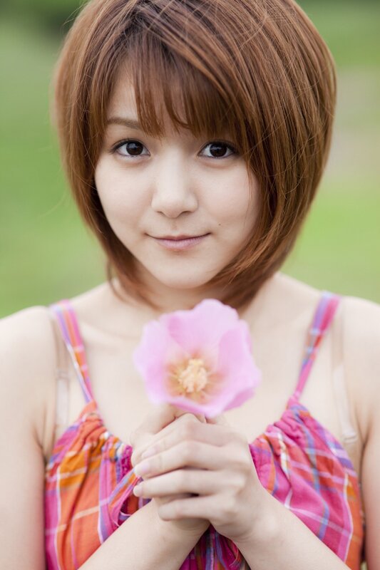 woman holding pink flower