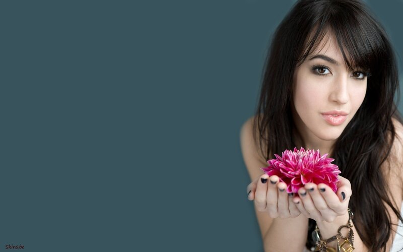 woman holding pink flower