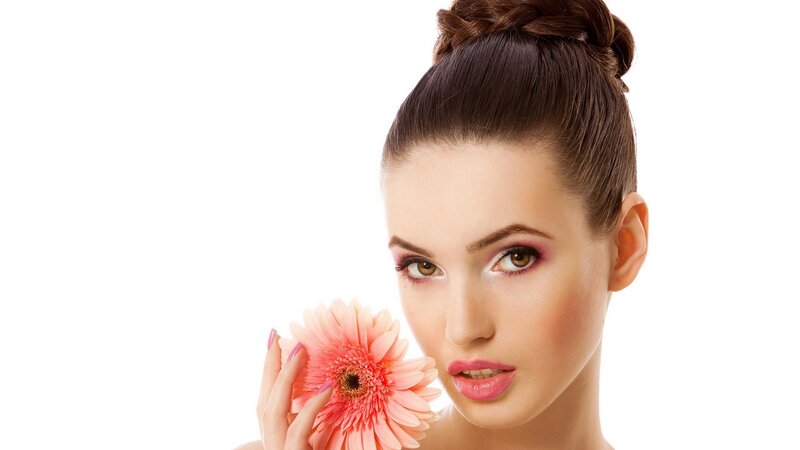 woman holding pink flower