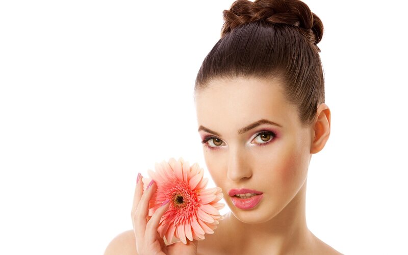 woman holding pink flower
