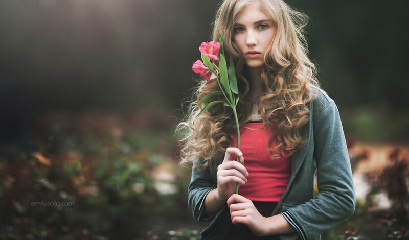 woman holding pink flower