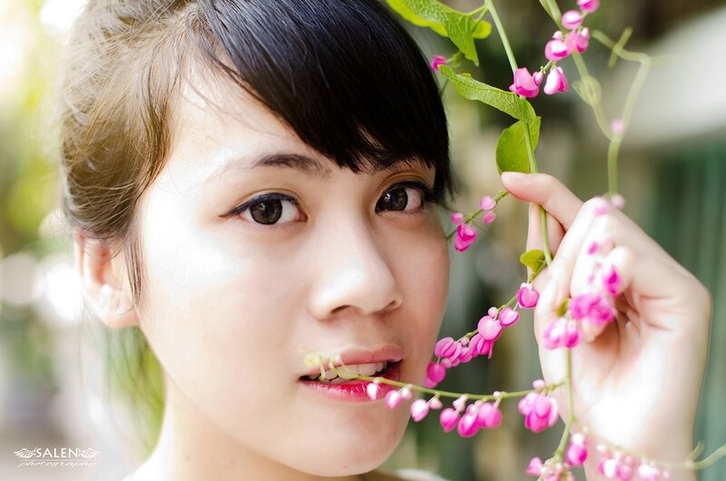 woman holding pink flowers