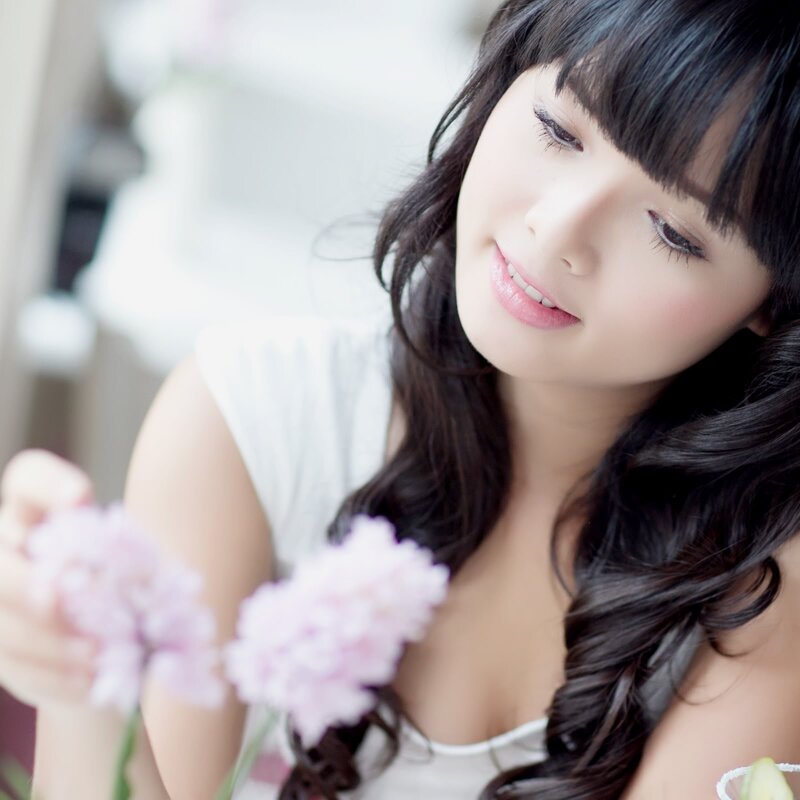 woman holding pink flowers