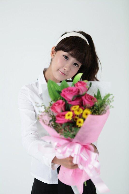 woman holding pink flowers