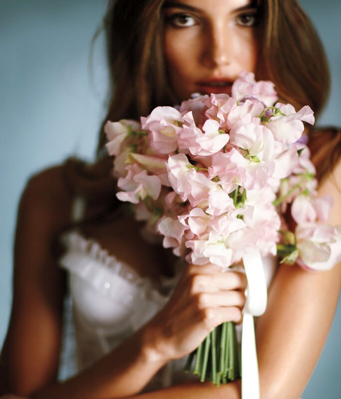 woman holding pink flowers